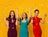 Three women celebrating while tossing up confetti.